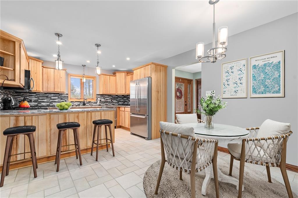 7005 Franklin Road Cranberry Township, PA 16066 - Photo 7 of 26 a dining room filled with lots of chairs and a chandelier