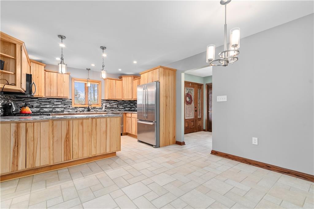 7005 Franklin Road Cranberry Township, PA 16066 - Photo 8 of 26 a view of kitchen with stainless steel appliances granite countertop a refrigerator a sink dishwasher and white cabinets with wooden floor