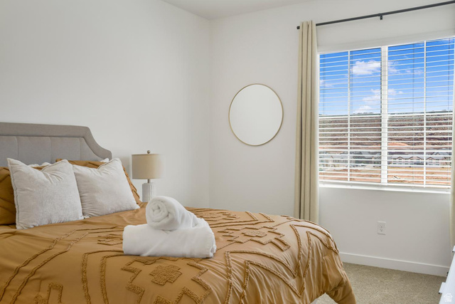 1705 Ripple Rock Drive, Unit 3017 Washington, UT 84780 - Photo 11 of 22 Bedroom featuring white walls and neutral carpet