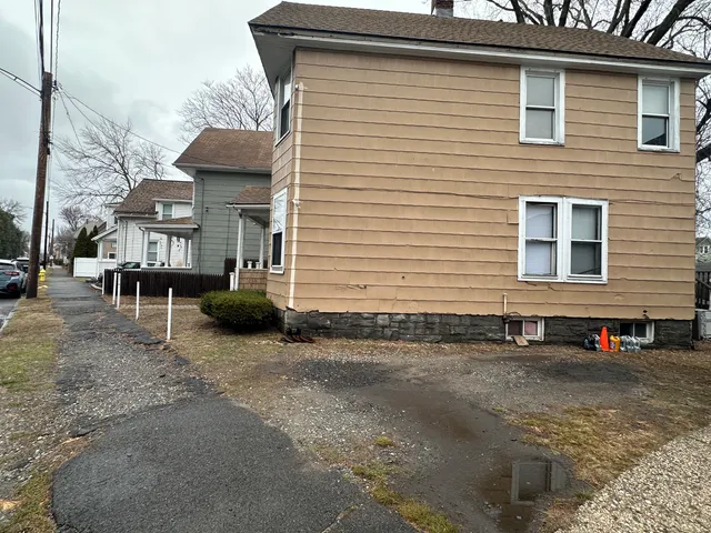 a view of a house with a backyard