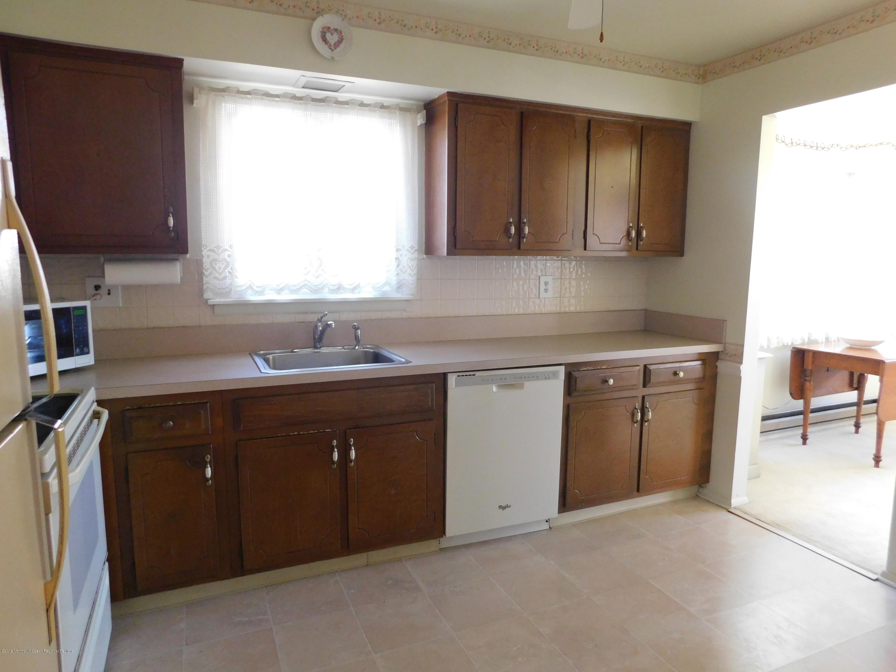 26 Masters Road Brick, NJ 08724 - Photo 6 of 14 a kitchen with a sink stove and cabinets