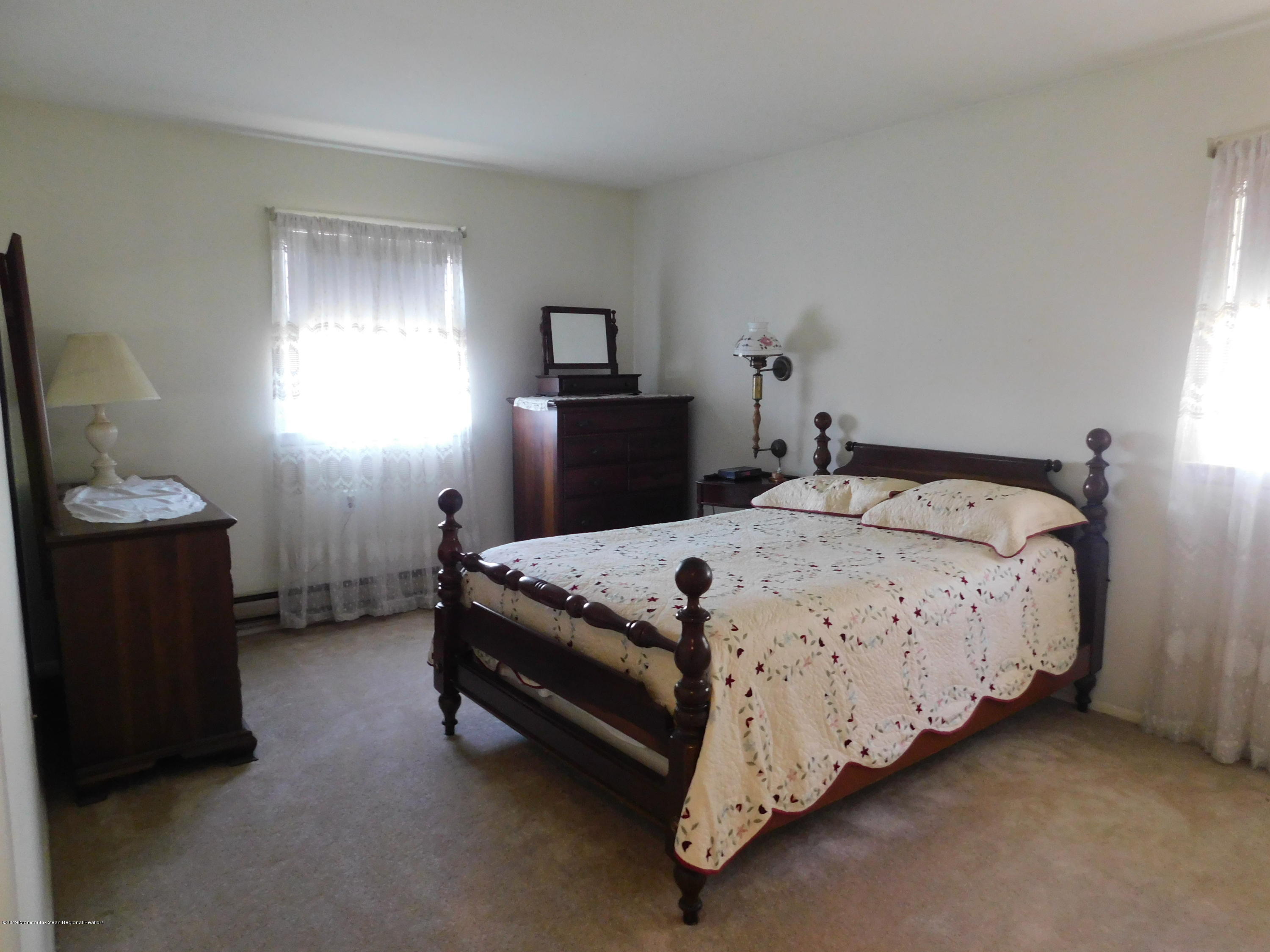 26 Masters Road Brick, NJ 08724 - Photo 8 of 14 a bedroom with a bed and a window