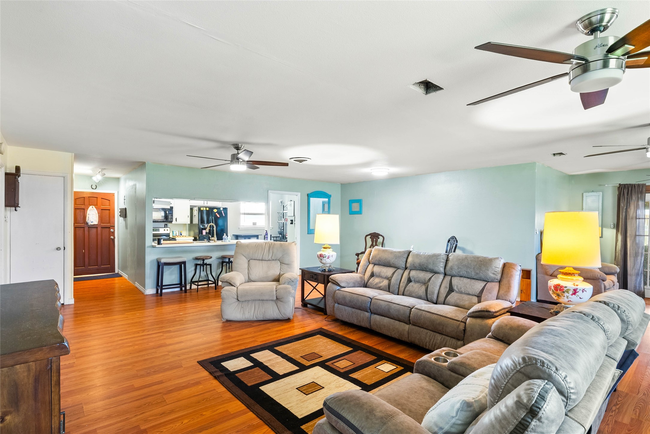168 Sunset Ingleside, TX 78362 - Photo 7 of 26 Alternative angle of the living room highlighting its versatility and seamless flow into adjacent rooms.