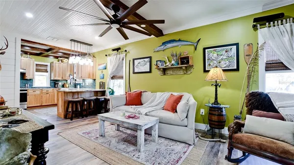 a living room with furniture and kitchen view