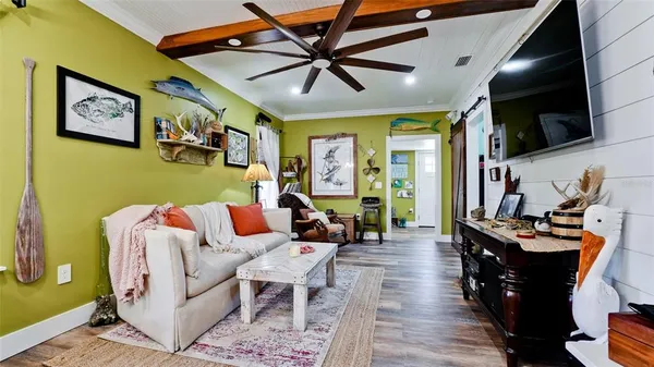 a living room with furniture and a flat screen tv