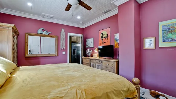 a bedroom with a bed and a flat screen tv