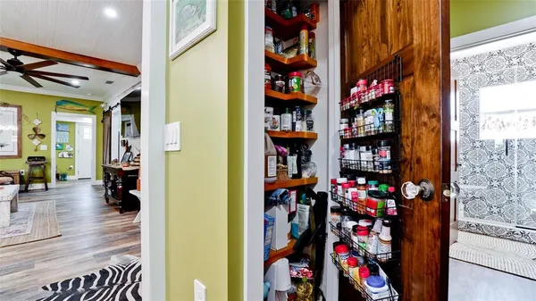 a view of kids room with toys and wooden floor