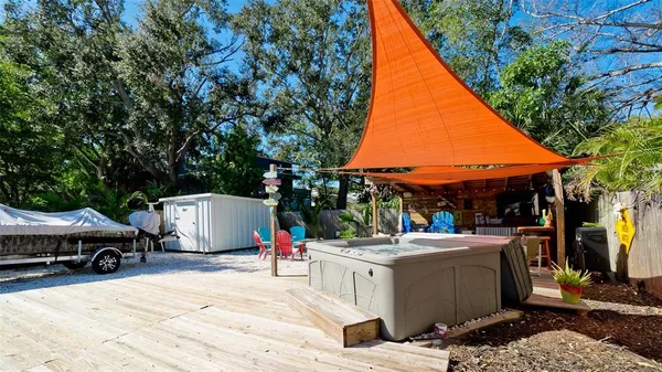 a view of a patio with table and chairs under an umbrella