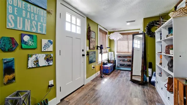 a hallway with painting on the wall and a window