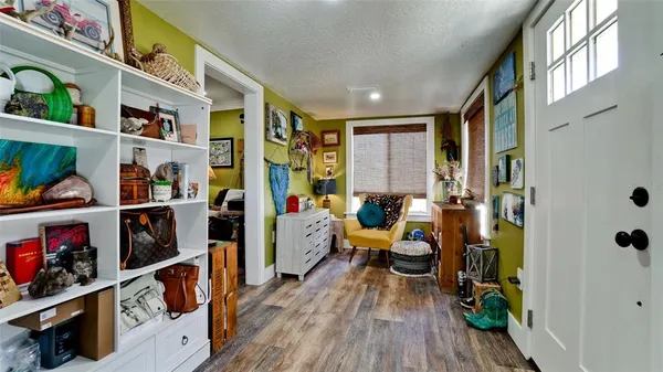 a living room with furniture and a book shelf