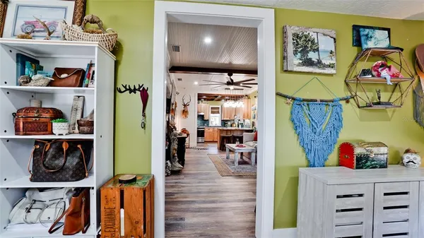 a living room with lots of furniture and clutter on the wall