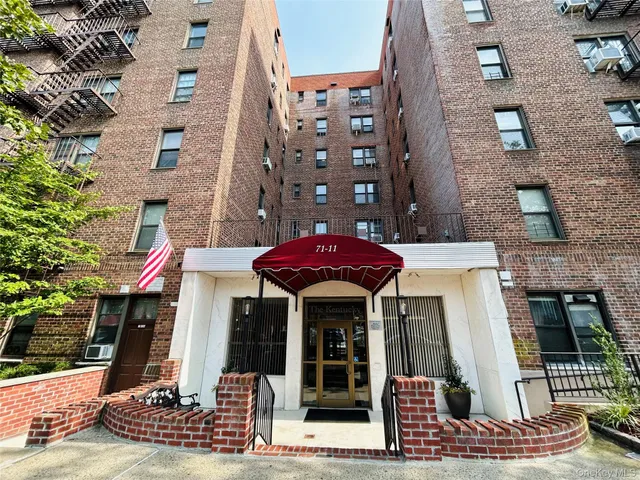 front view of a building with a garden