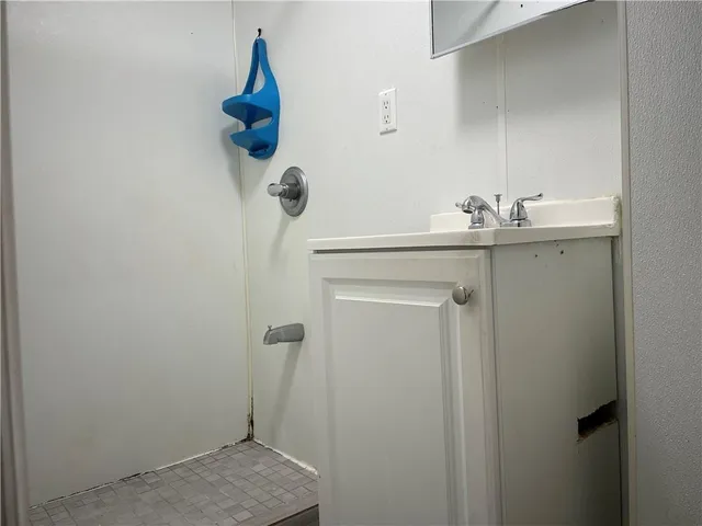 a bathroom with a sink and mirror