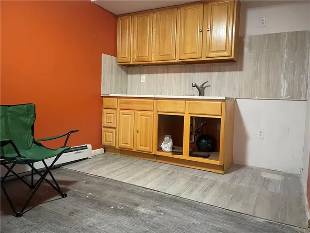 a view of an empty room with a fireplace and a window