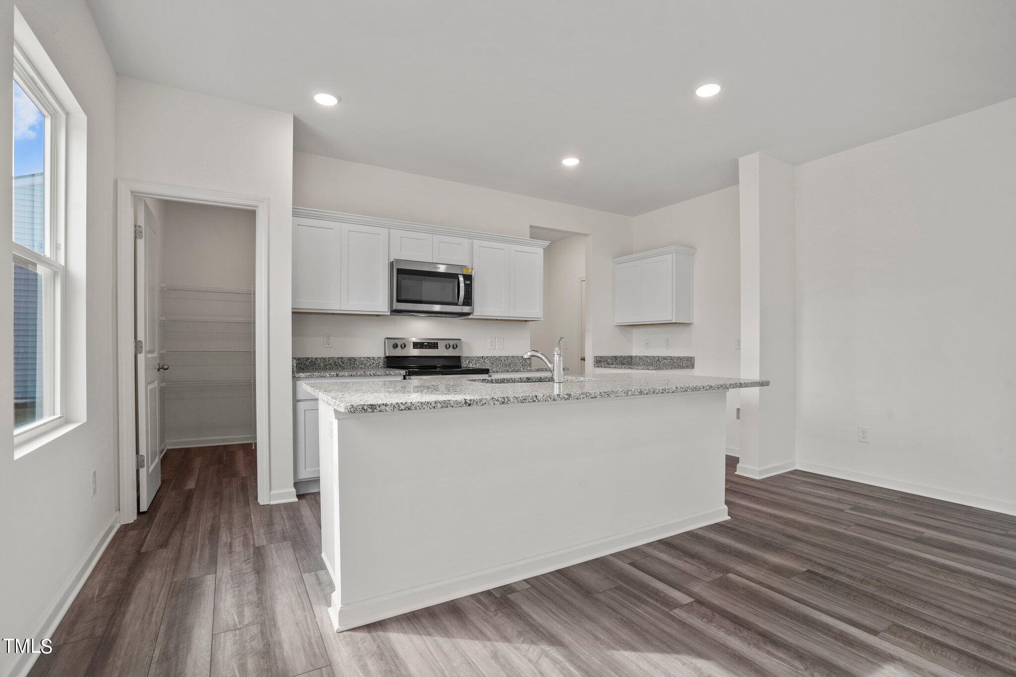 800 Piaggio Lane Spring Hope, NC 27882 - Photo 30 of 33 a kitchen with stainless steel appliances a refrigerator and a stove top oven