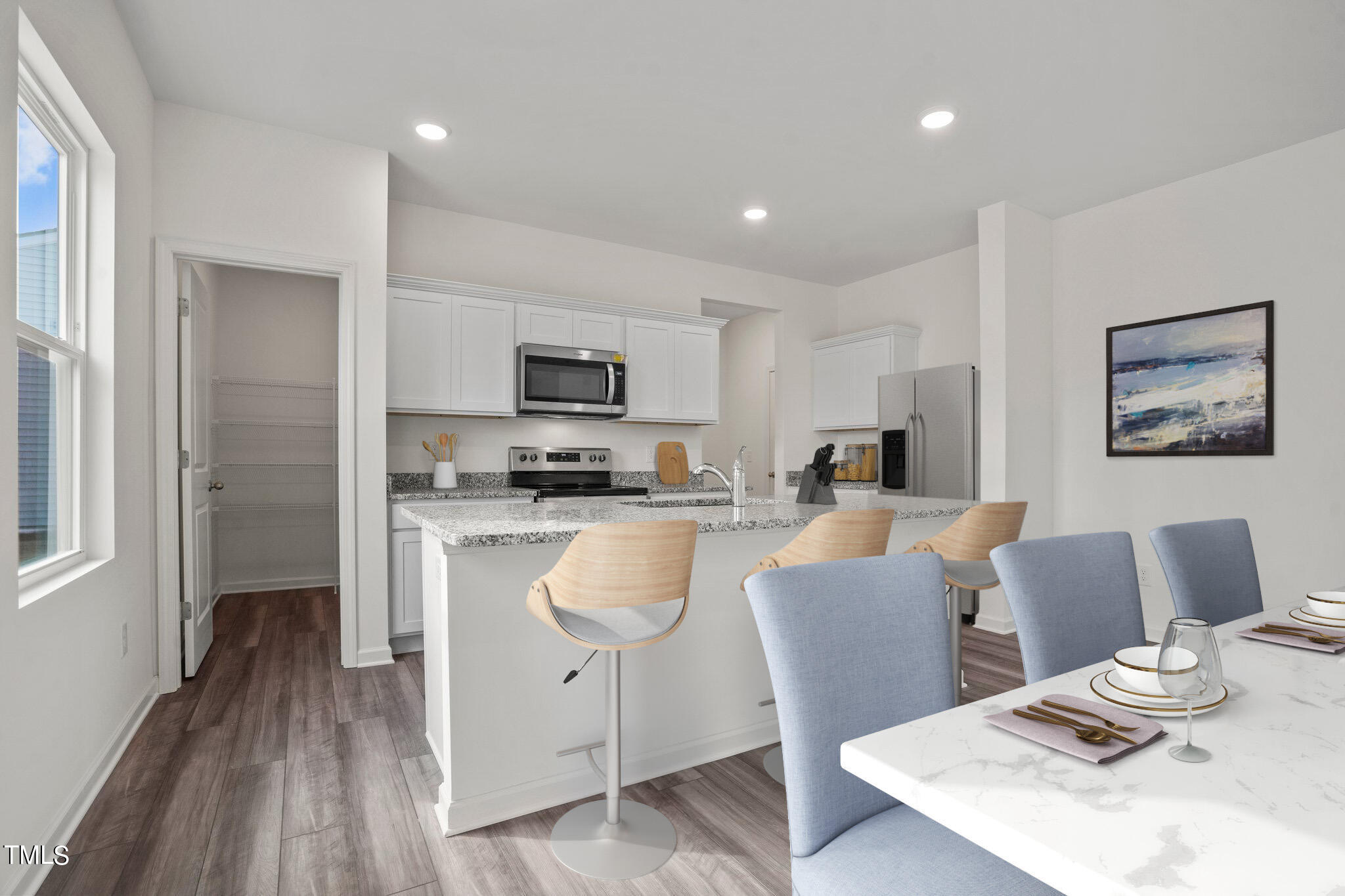 800 Piaggio Lane Spring Hope, NC 27882 - Photo 4 of 33 a kitchen with stainless steel appliances granite countertop a refrigerator a stove top oven a sink dishwasher and white cabinets with wooden floor