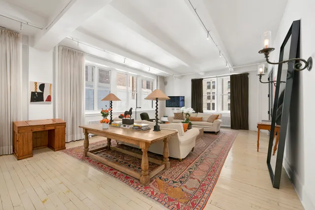 a living room with furniture a fireplace and a table