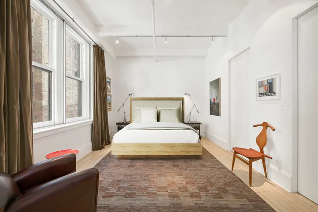 a kitchen with stainless steel appliances granite countertop a dining table chairs refrigerator and sink