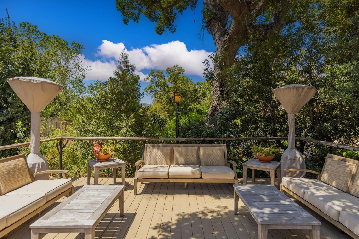 868 Fairview Road Ojai, CA 93023 - Photo 2 of 15 a view of a balcony with couches and wooden floor