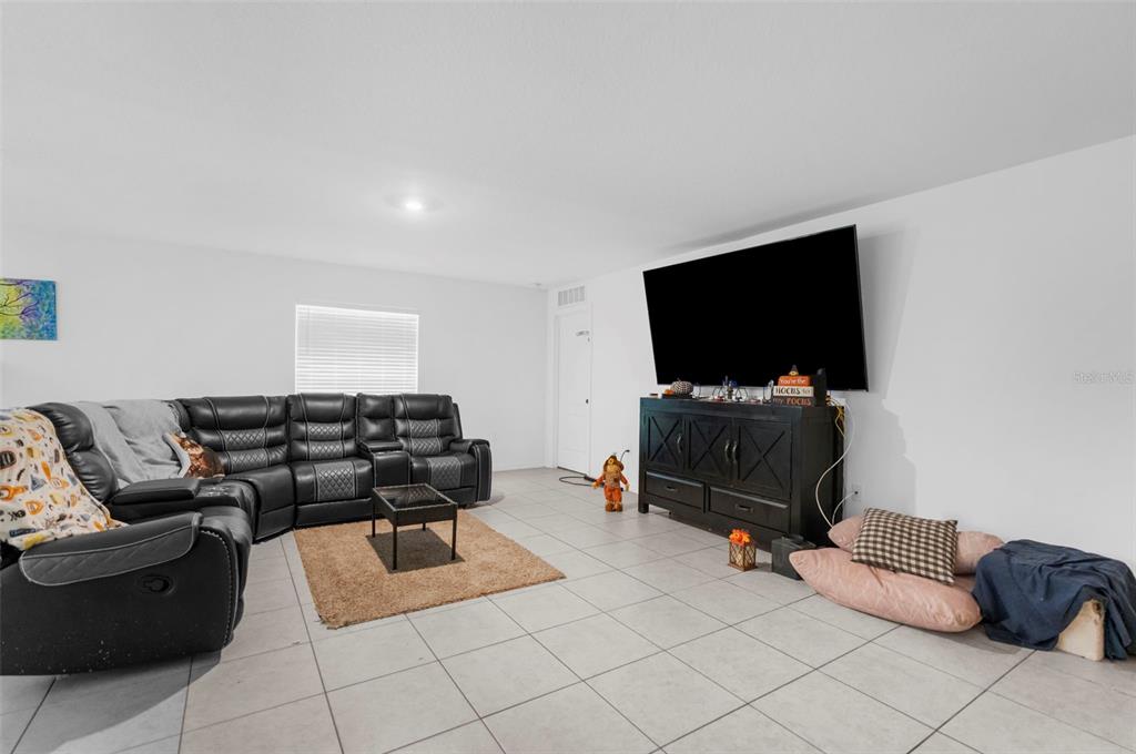 5637 East Tangelo Lane Inverness, FL 34453 - Photo 5 of 23 a living room with furniture and a flat screen tv