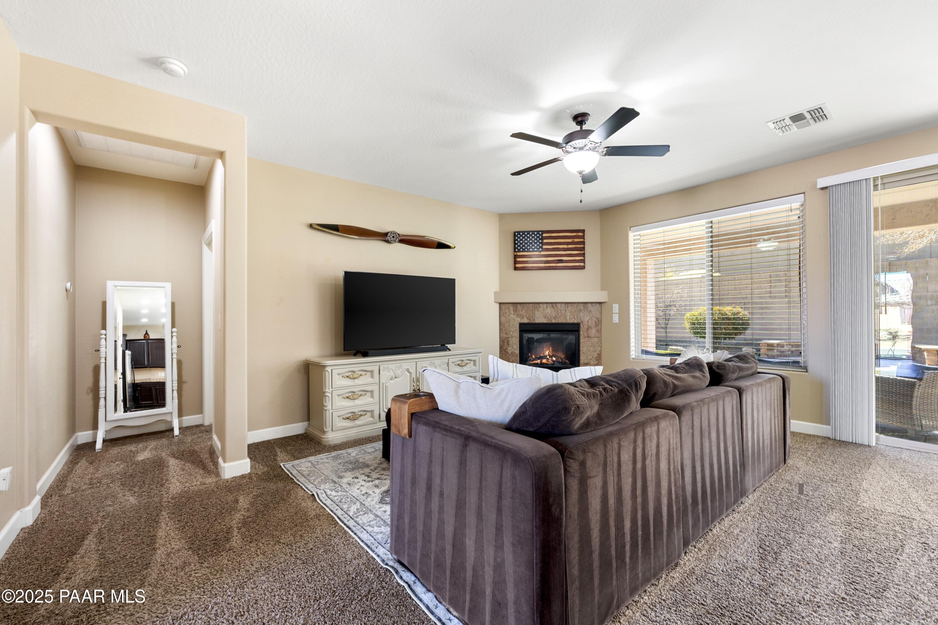 1200 Rusty Nail Road Prescott Valley, AZ 86314 - Photo 10 of 32 a living room with furniture a flat screen tv and a fireplace