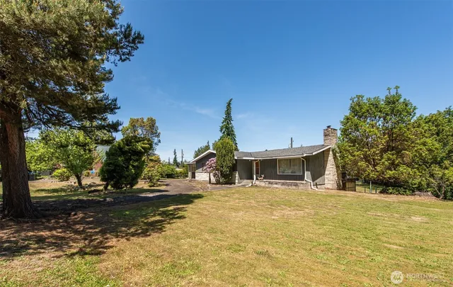 a view of a white house with a yard