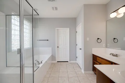 a spacious bathroom with a tub and shower