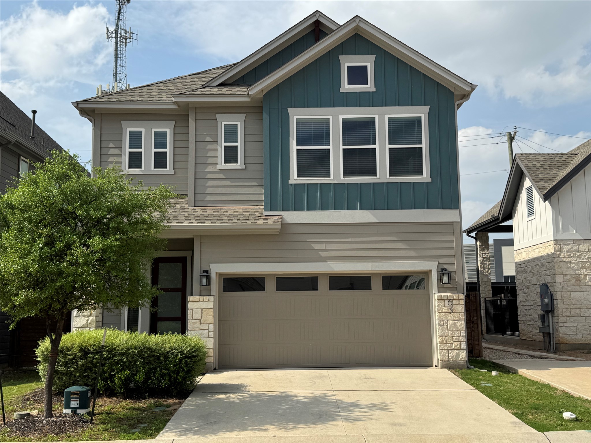 3000 Chisholm Trail Road, Unit 63 Round Rock, TX 78681 - Photo 1 of 31 Craftsman-style home with a garage, driveway, board and batten siding, and stone siding