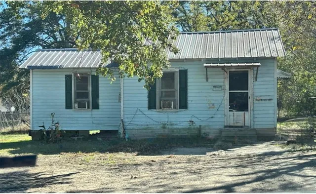 a view of a house with a yard and sitting area