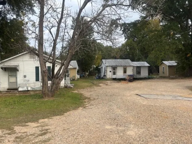 a house view with a sitting space and garden