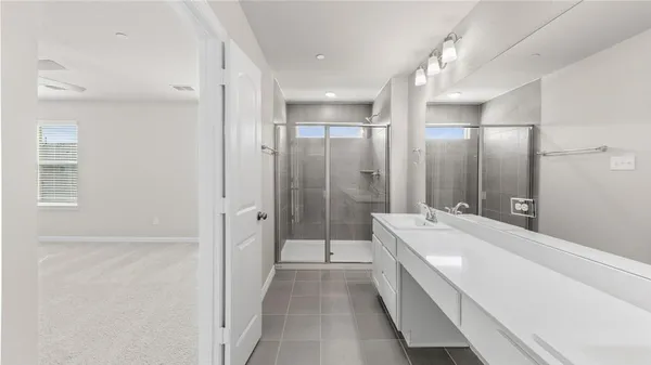 a bathroom with a tub sink shower and mirror