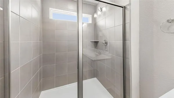 a bathroom with a glass shower door