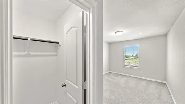 a view of an empty room and a window