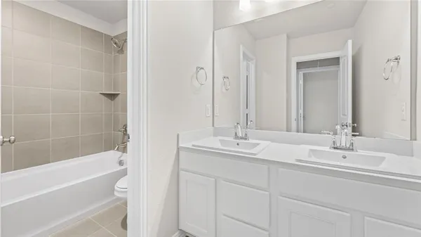 a bathroom with a tub sink and mirror