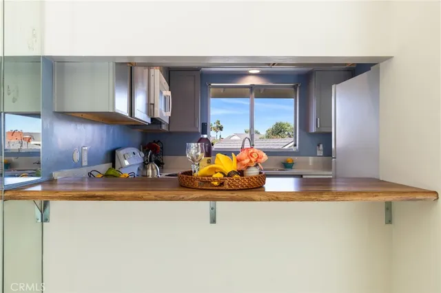 a kitchen with a sink a refrigerator and cabinets