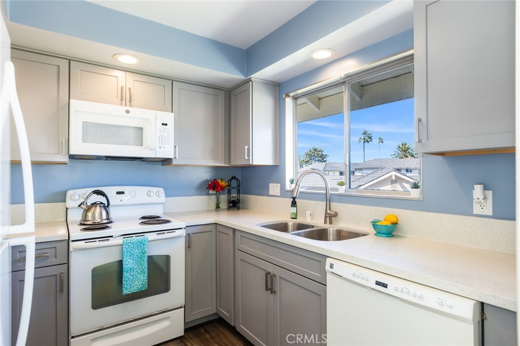 23026 Nadine Circle, Unit B Torrance, CA 90505 - Photo 17 of 56 a kitchen with a sink a stove and cabinets