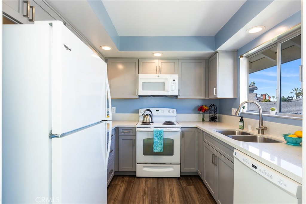 23026 Nadine Circle, Unit B Torrance, CA 90505 - Photo 18 of 56 a kitchen with a sink a refrigerator and cabinets