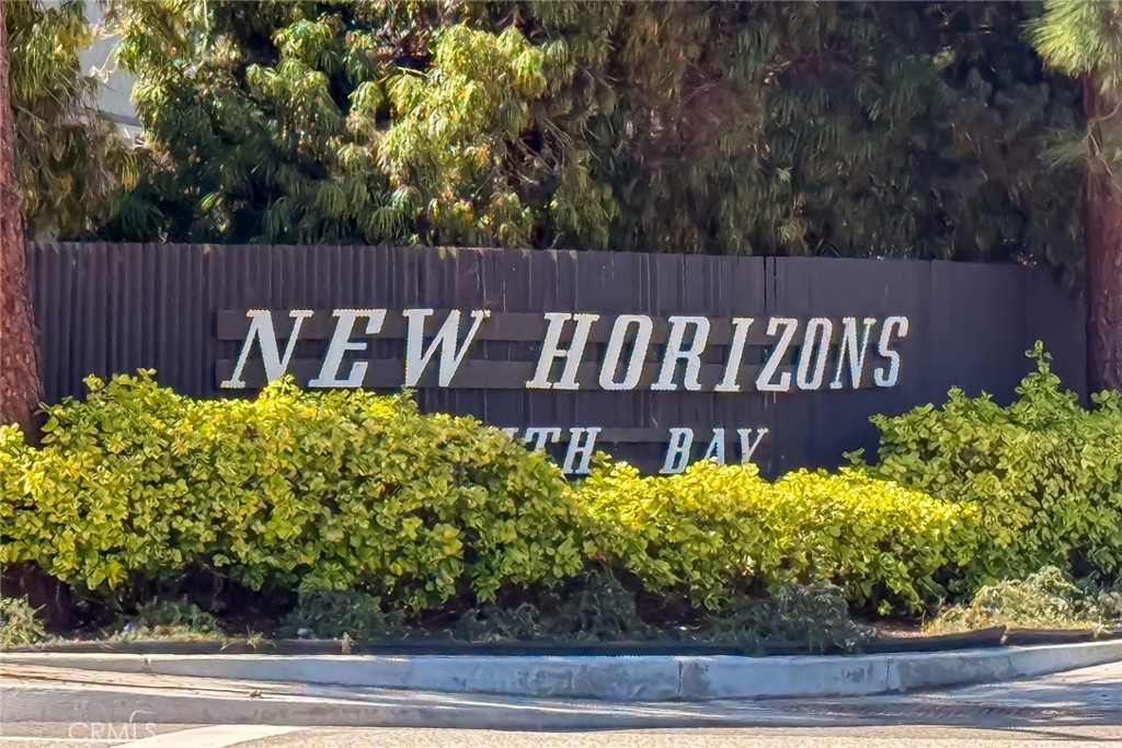 23026 Nadine Circle, Unit B Torrance, CA 90505 - Photo 2 of 56 a view of a sign board with flower plants