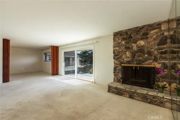 a view of an empty room with a fireplace