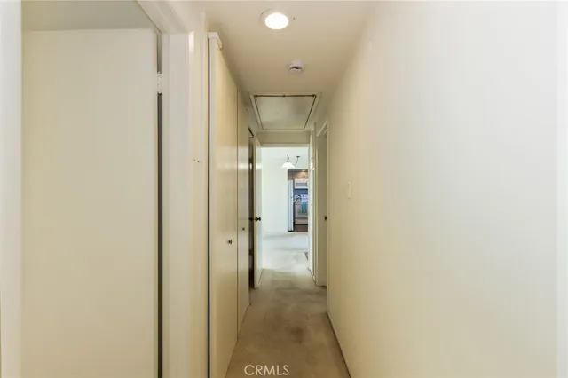 an empty room with sliding glass door and shower