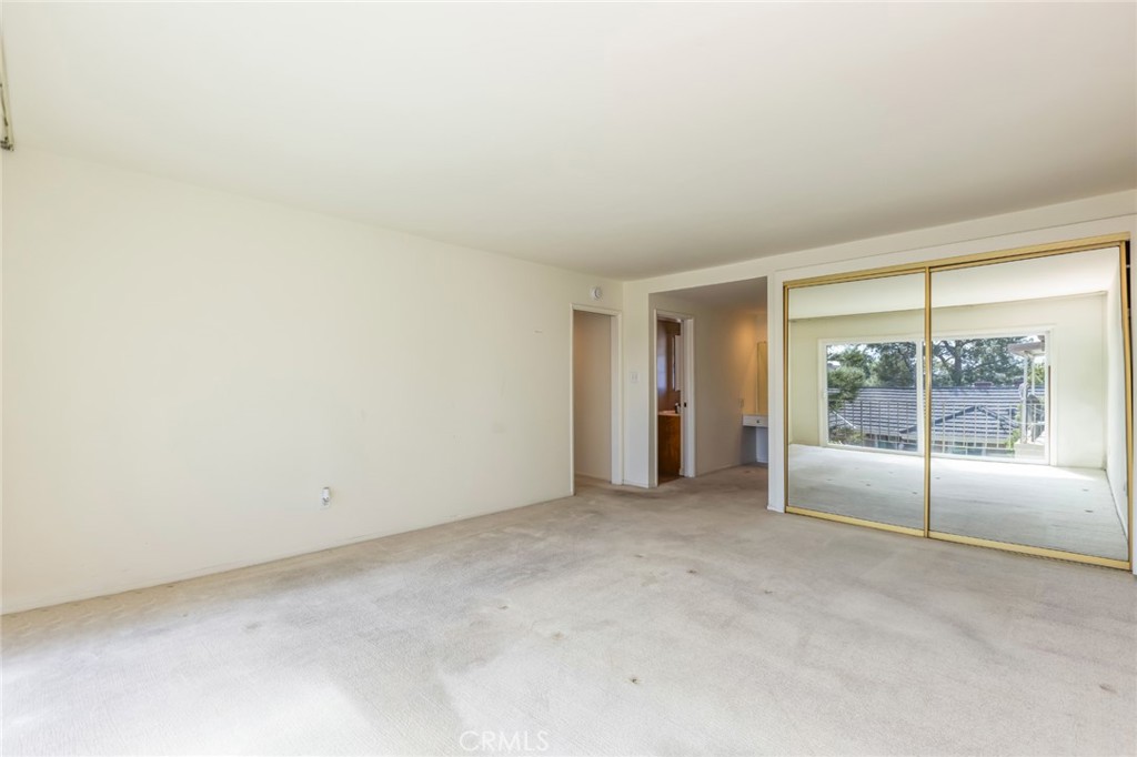 23026 Nadine Circle, Unit B Torrance, CA 90505 - Photo 25 of 56 an empty room with sliding glass door and shower