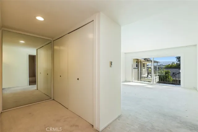 a view of a big room with closet and windows