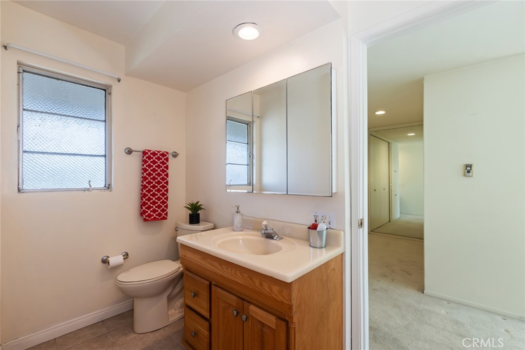 23026 Nadine Circle, Unit B Torrance, CA 90505 - Photo 29 of 56 a bathroom with a toilet sink and mirror