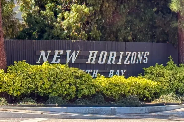 a view of a sign board with flower plants