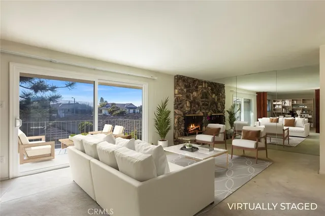 a view of a big room with large windows and fireplace