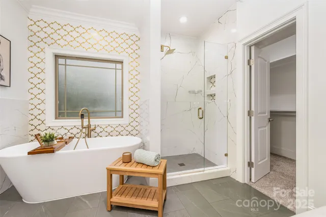 a bathroom with a tub sink and mirror