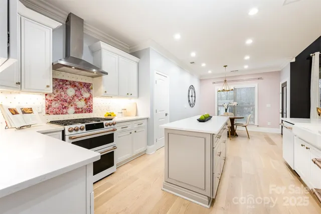 a kitchen with white cabinets and appliances