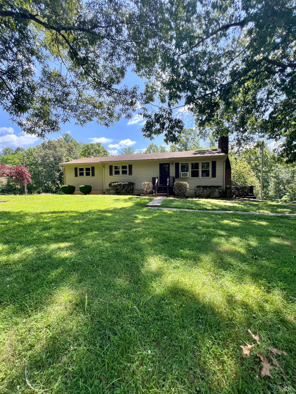 2785 Pera Road Monroe, VA 24574 - Photo 1 of 45 a view of a house with a big yard and large trees