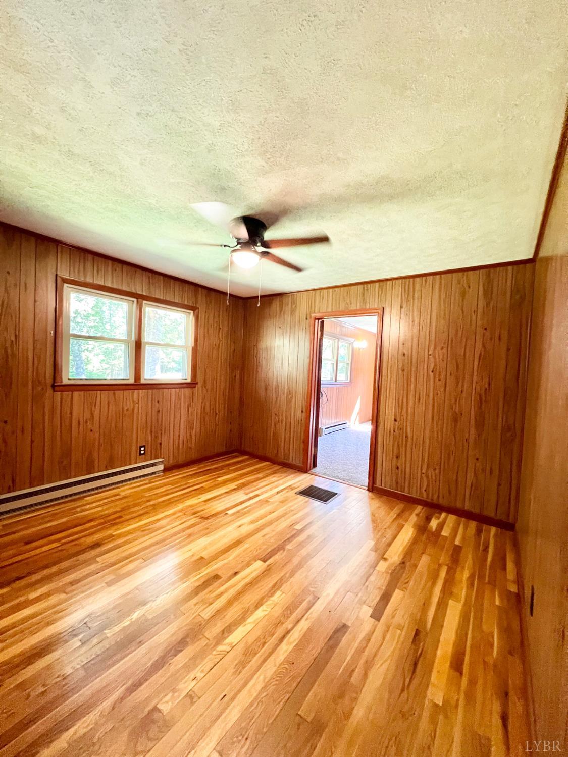 2785 Pera Road Monroe, VA 24574 - Photo 7 of 45 an empty room with wooden floor and windows