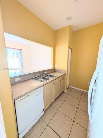a kitchen that has a sink and a stove